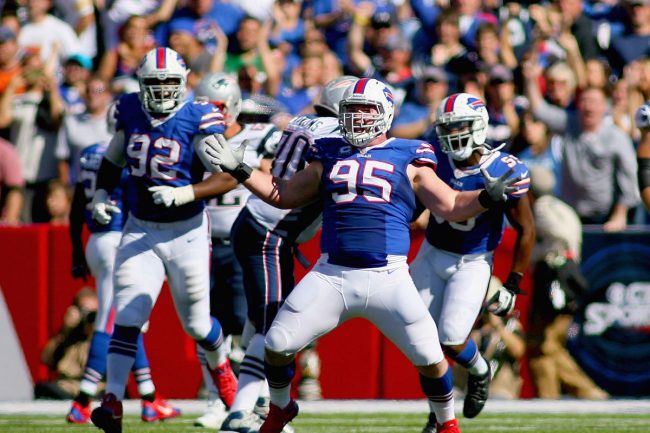 Bills player 95 reacts energetically after a big play.