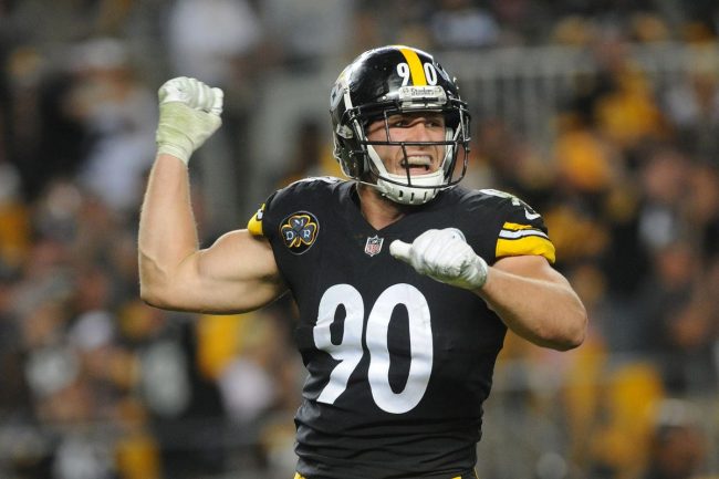 Steelers player in black jersey celebrates on field.