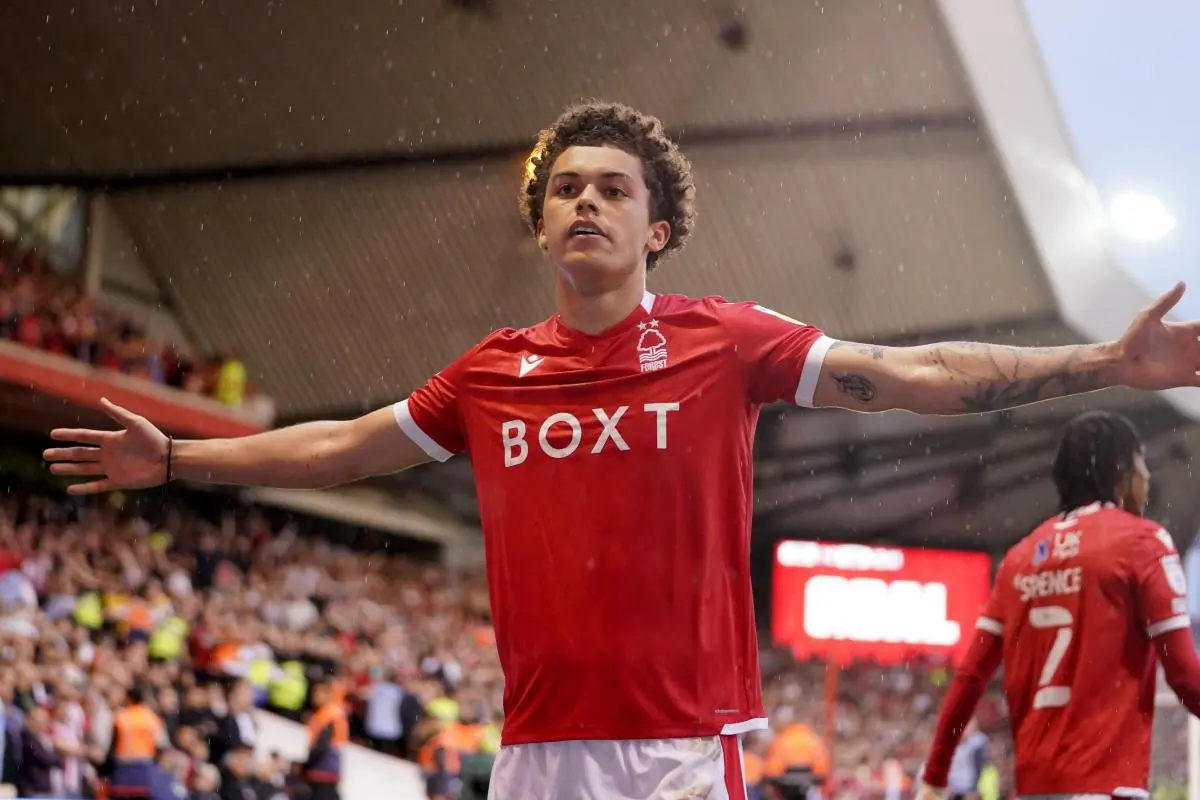 Footballer in red jersey celebrating on the field.