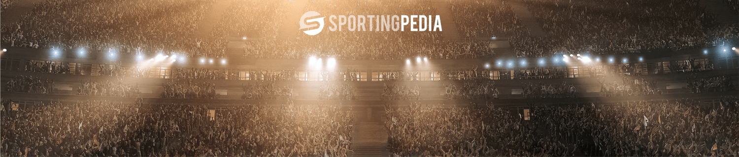 Packed sports stadium with 'SportingPedia' logo, spotlights overhead.