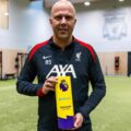 Liverpool's manager Arne Slot posing with the Manager of the Month award for November