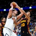 Nikola Jokic battling under the basket with Atlanta players