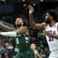 Damian Lillard with a lay up in front of Joel Embiid