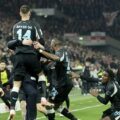 Bayer Leverkusen players celebrate after scoring a stoppage time winner against Stuttgart