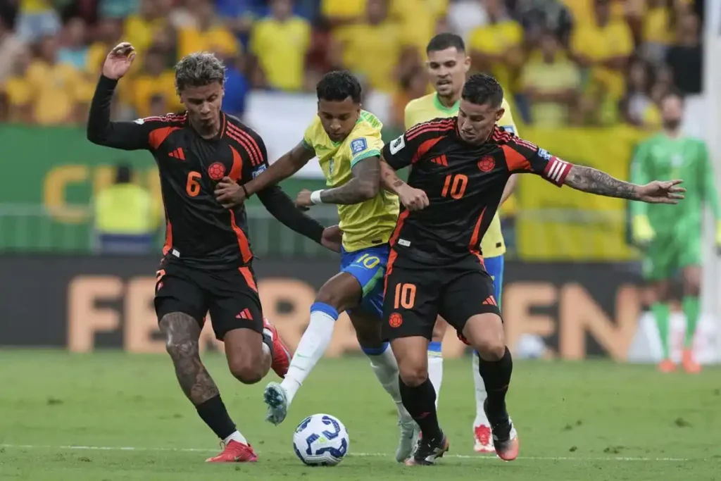 Brazil's Rodrygo and Colombia's James Rodriguez battle for the ball