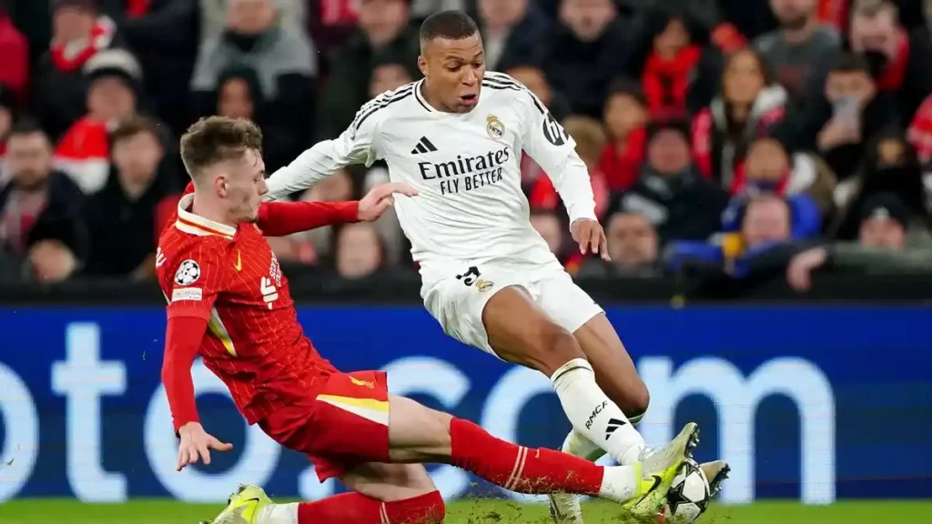 Conor Bradley with a sliding tackle on Kylian Mbappe
