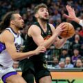 Cleveland's Ty Jerome guarded by Sacramento's Devin Carter