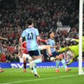 Arsenal's goalkeeper blocks a shot from Manchester United player