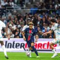 Desire Doue dribbles between multiple Marseille defenders