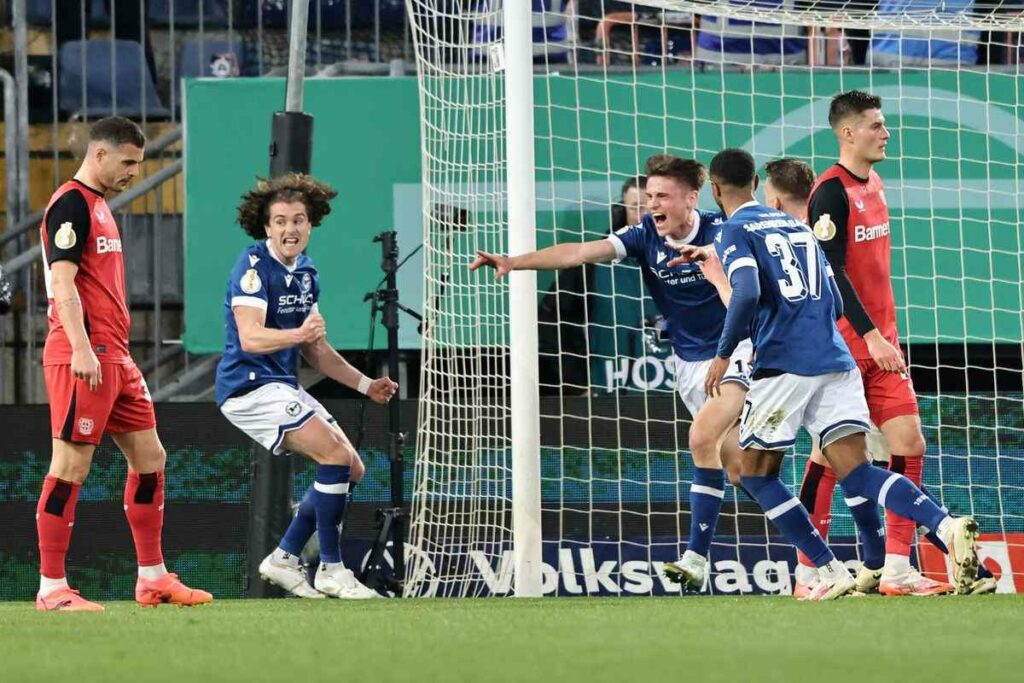 The players of third-division Arminia Bielefeld have just scored against defending champions Bayer Leverkusen