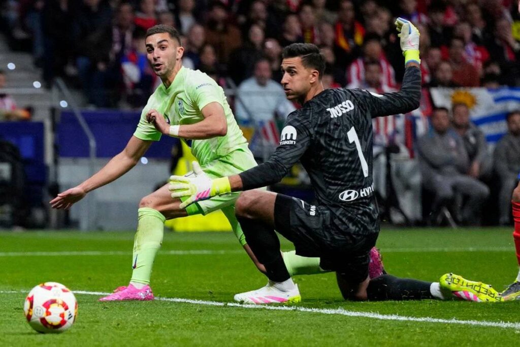 Ferran Torres and Juan Musso watch as the ball goes towards Atletico Madrid net
