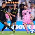 Leo Messi passing the ball as Noah Allen watches