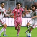 Lionel Messi driblles between 2 Toronto players