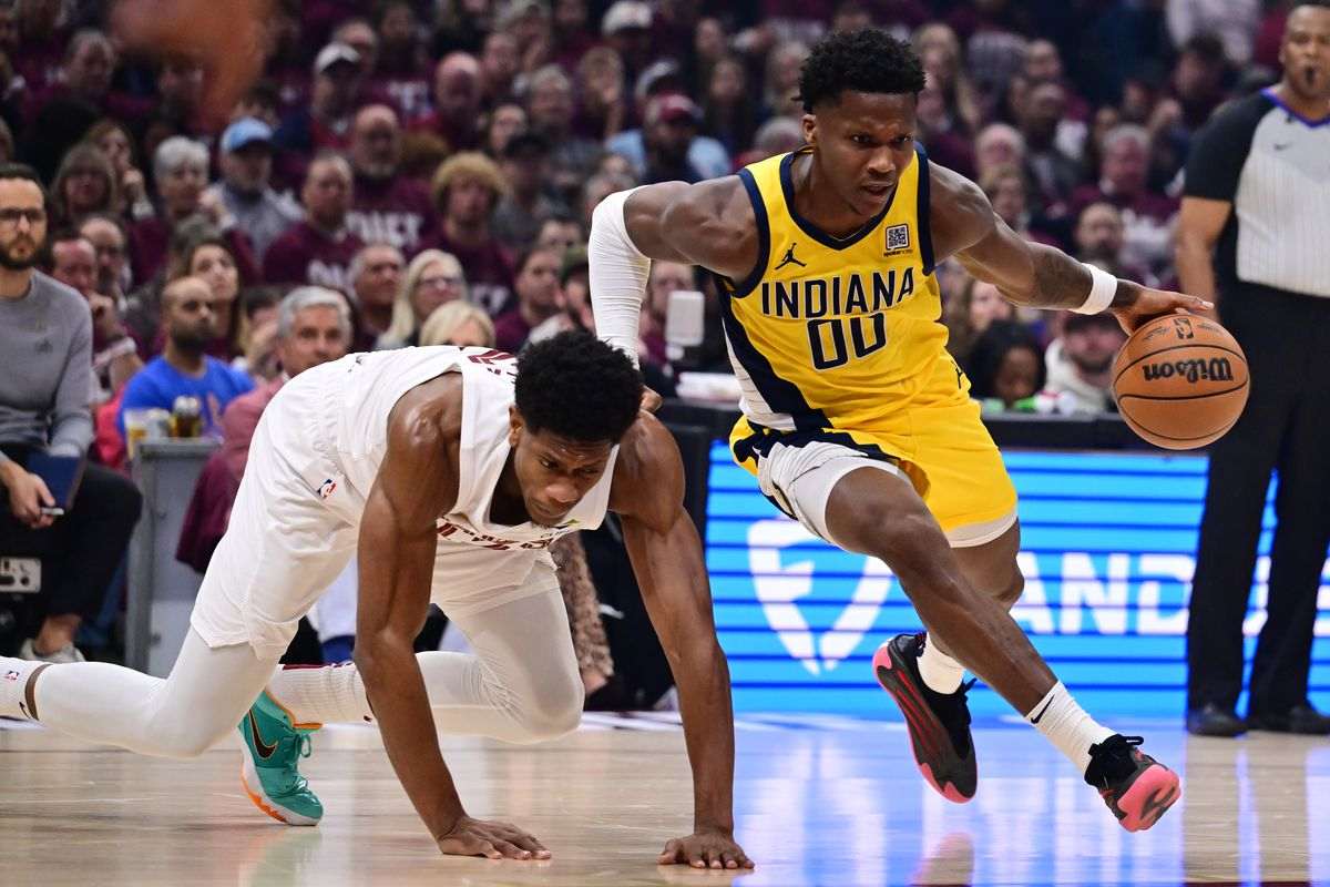 Bennedict Mathurin dribbles past a Cleveland Cavaliers player