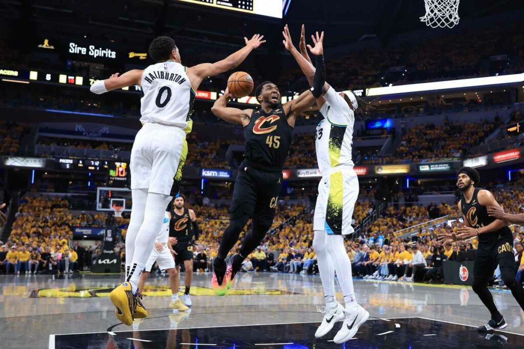 Donovan Mitchell trying to dunk in Indiana's basket