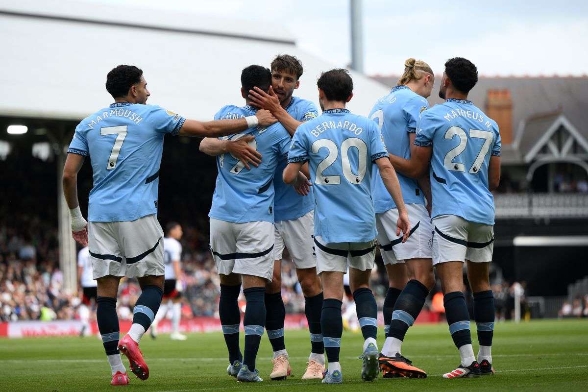 Manchester City players celebrate after scoring