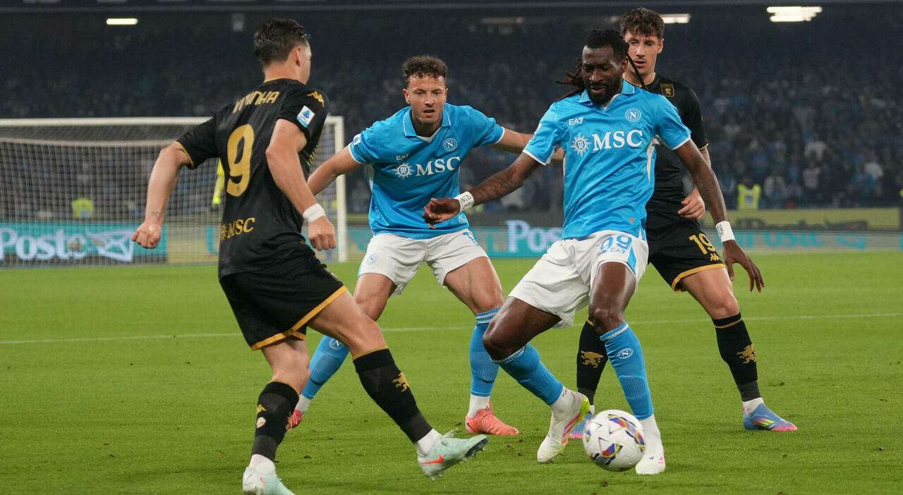Players of Genoa and Napoli battle for the ball