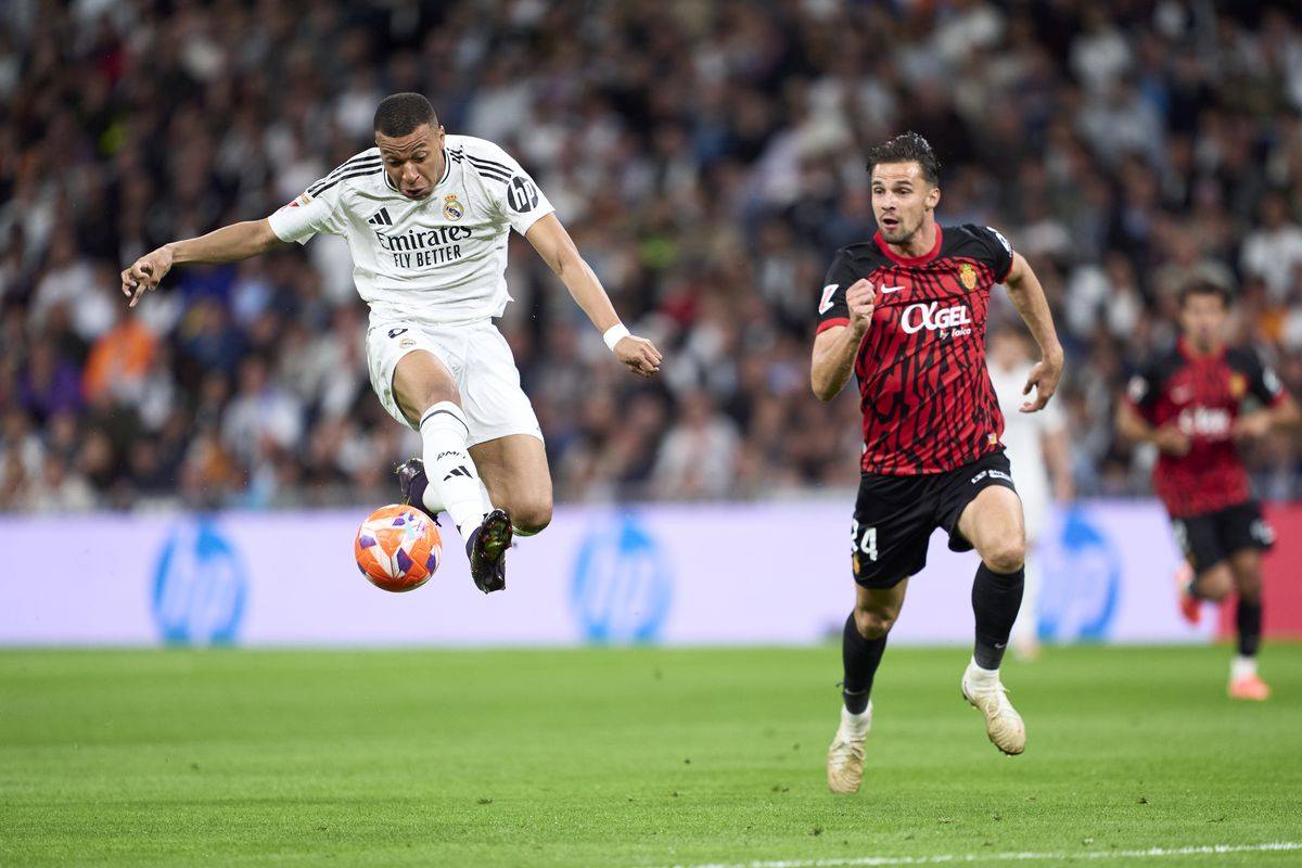 Kylian Mbappe controls the ball at pace