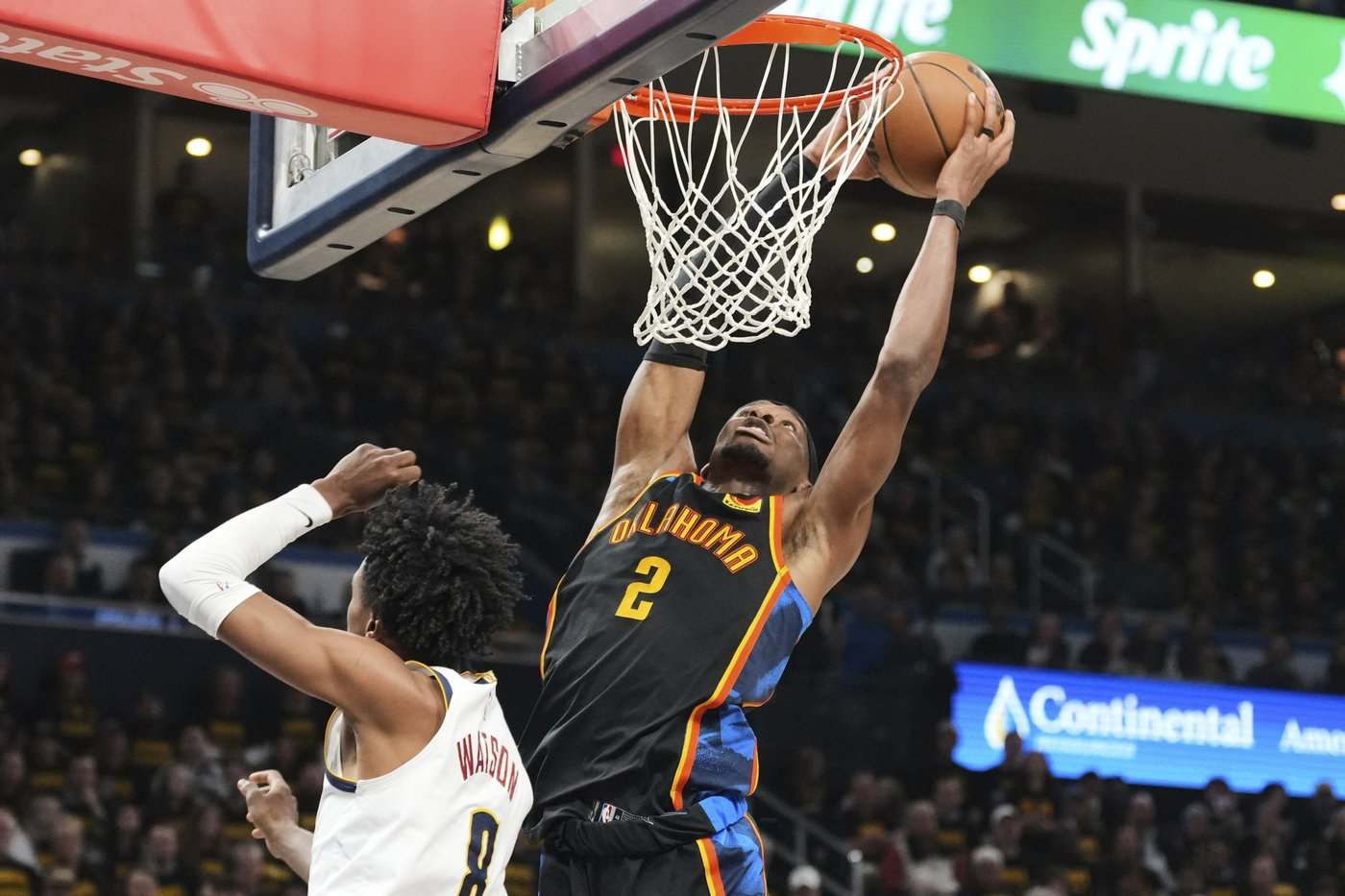 Shai Gilgeous-Alexander dunks the ball over Peyton Watson
