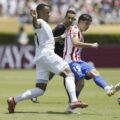 Botafogo player puts pressure on Atletico Madrid defender