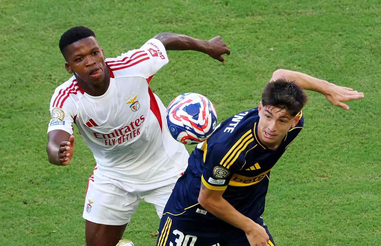 Players from Benfica and Boca Juniors battle for the ball