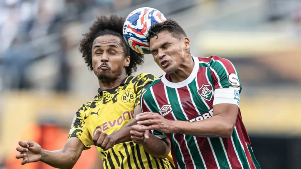 Karim Adeyemi and Thiago Silva battle for a high ball