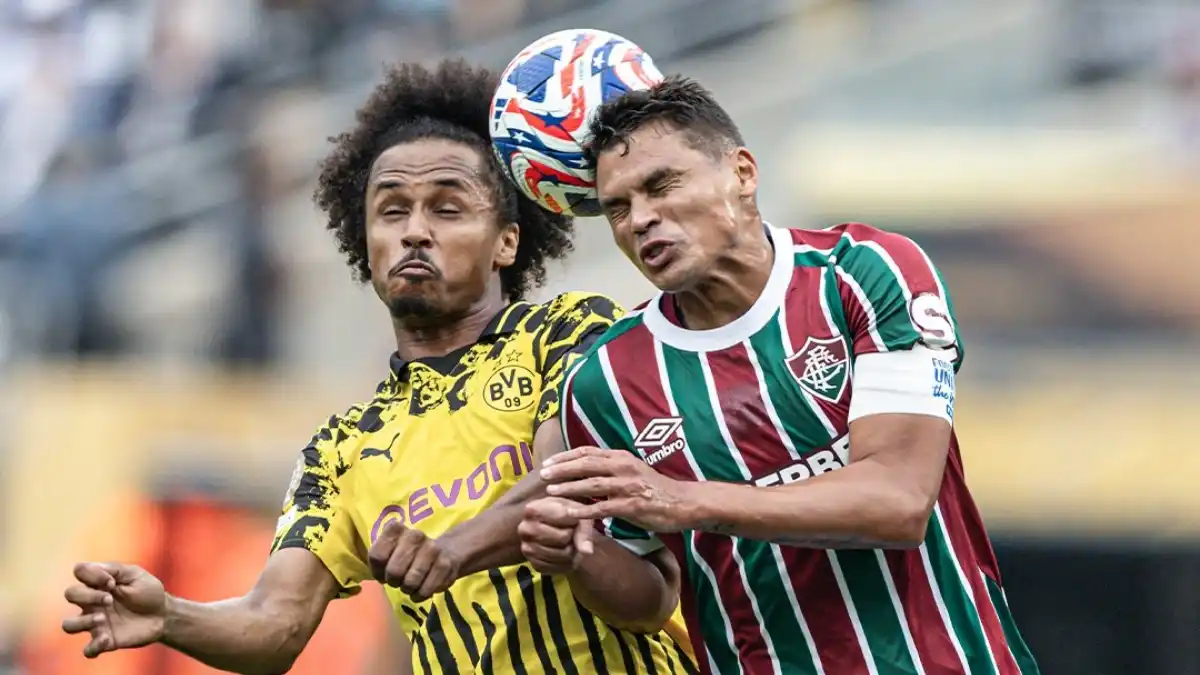 Karim Adeyemi and Thiago Silva battle for a high ball