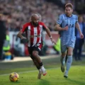 Brentford forward Bryan Mbeumo trying to escape from a Tottenham player