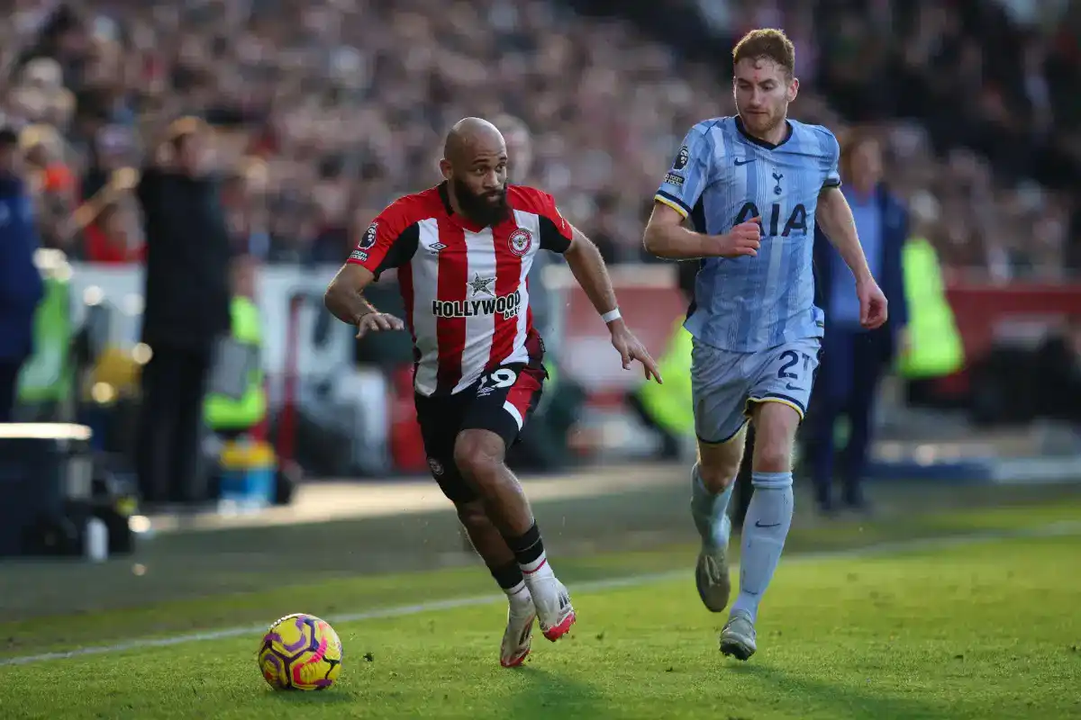 Brentford forward Bryan Mbeumo trying to escape from a Tottenham player