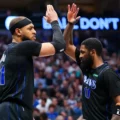 Dallas Mavericks players Daniel Gafford and Kyrie Irving hi-fiving