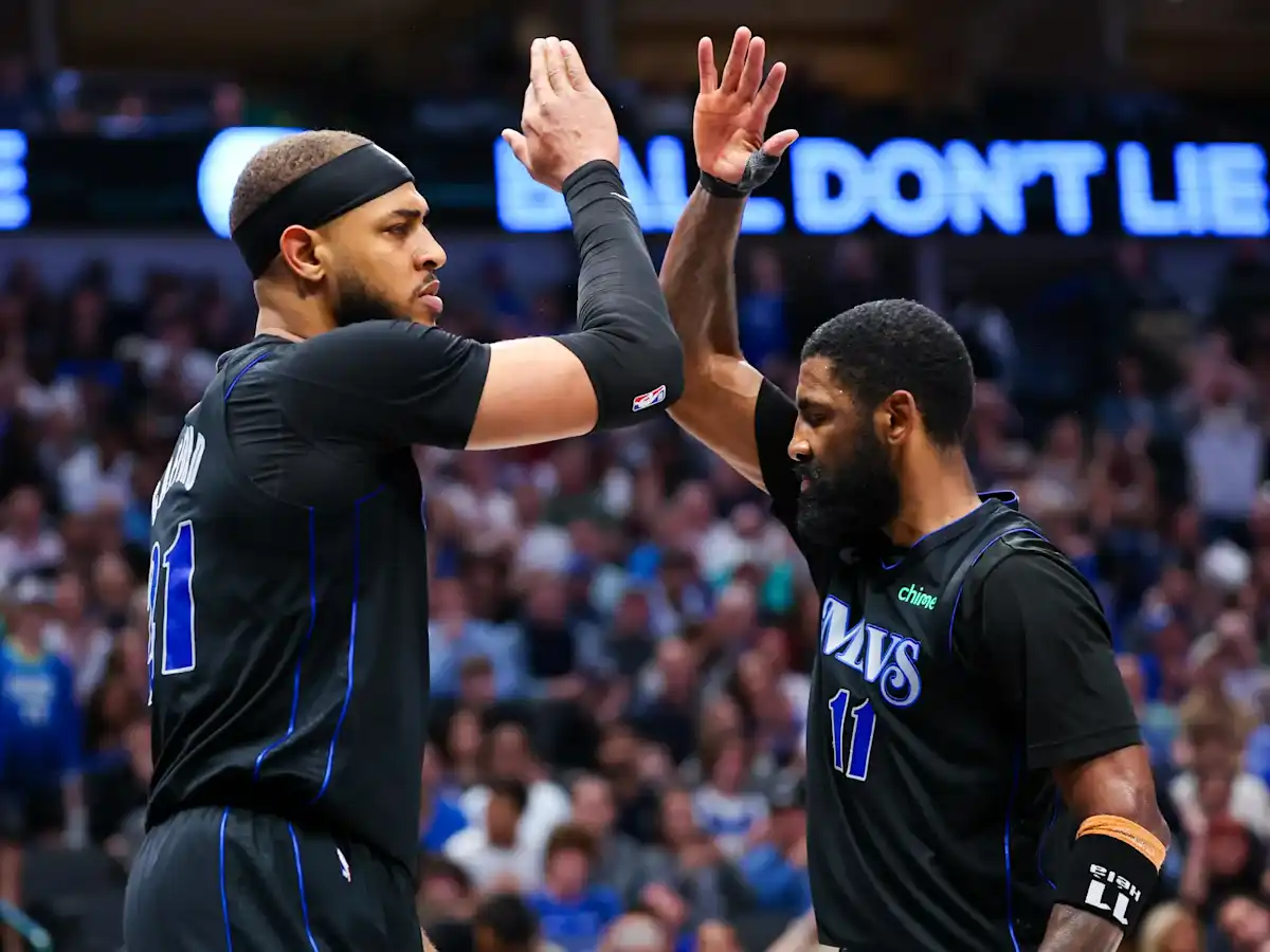Dallas Mavericks players Daniel Gafford and Kyrie Irving hi-fiving