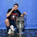 Khvicha Kvaratskhelia posing with the Champions League trophy