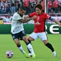 Monterrey player protects the ball from Urawa Red Diamonds captain