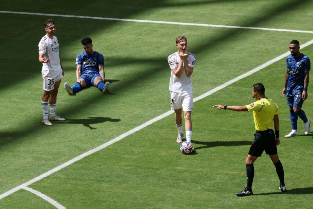 Referee points to the spot after Raul Asencio fouls Al-Hilal player in Real Madrid penalty box