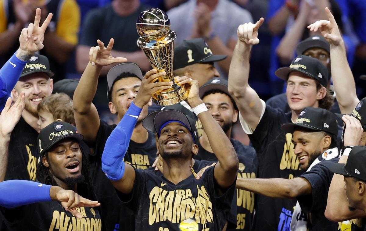 Shai Gilgeous-Alexander and the Oklahoma City Thunder with the NBA Championship trophy