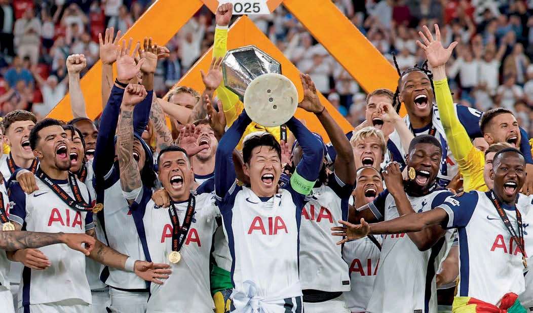 Tottenham players celebrate with the Europa League trophy