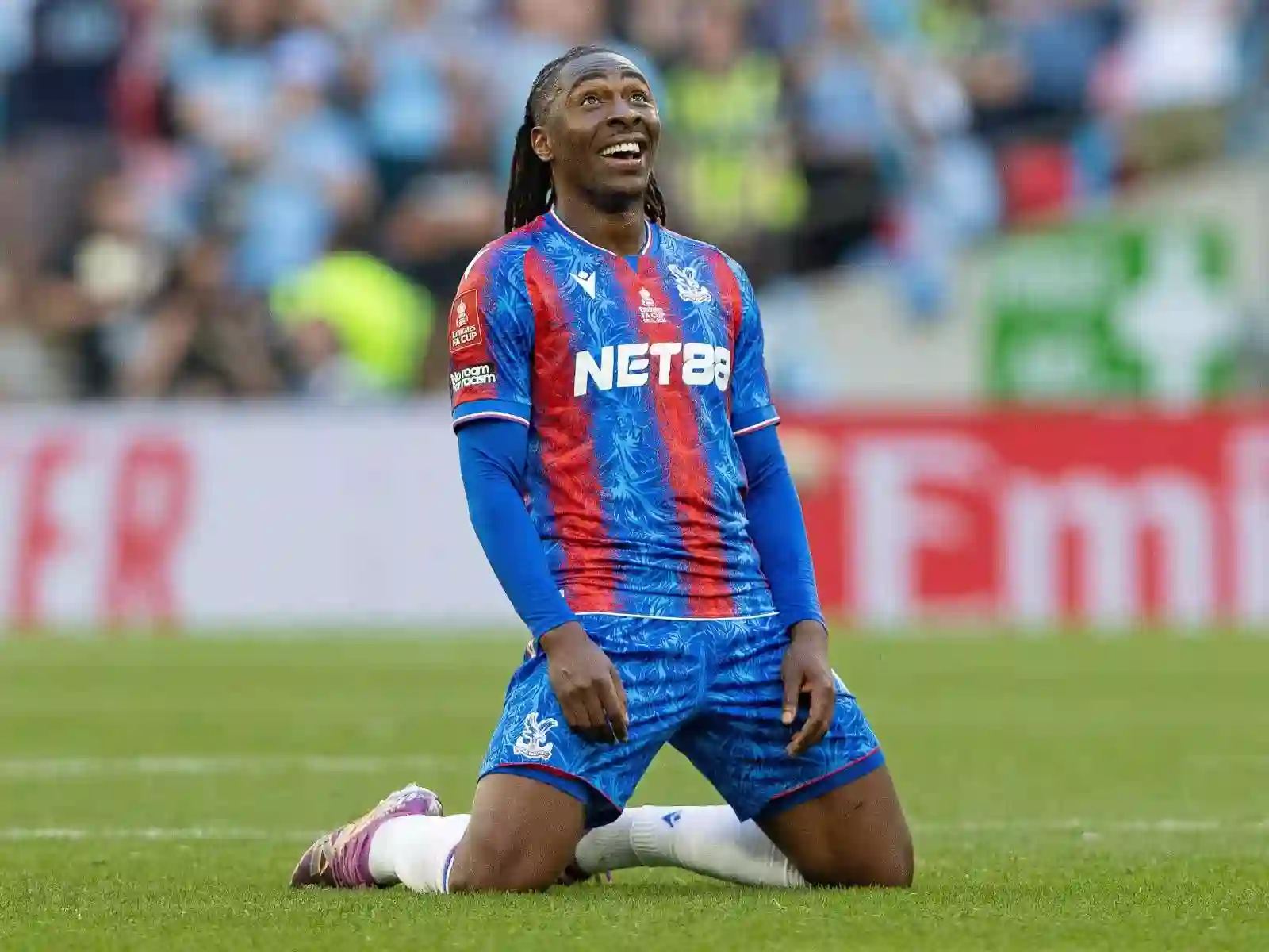 Eberechi Eze on his knees, smiling