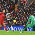 Alexander Isak shoots towards Liverpool goal under pressure by Virgil Van Dijk
