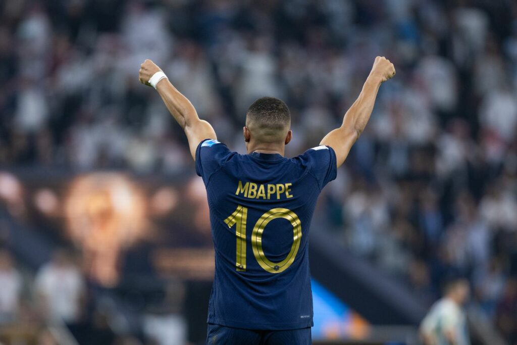 Kylian Mbappe with hands raised high