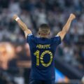 Kylian Mbappe with hands raised high