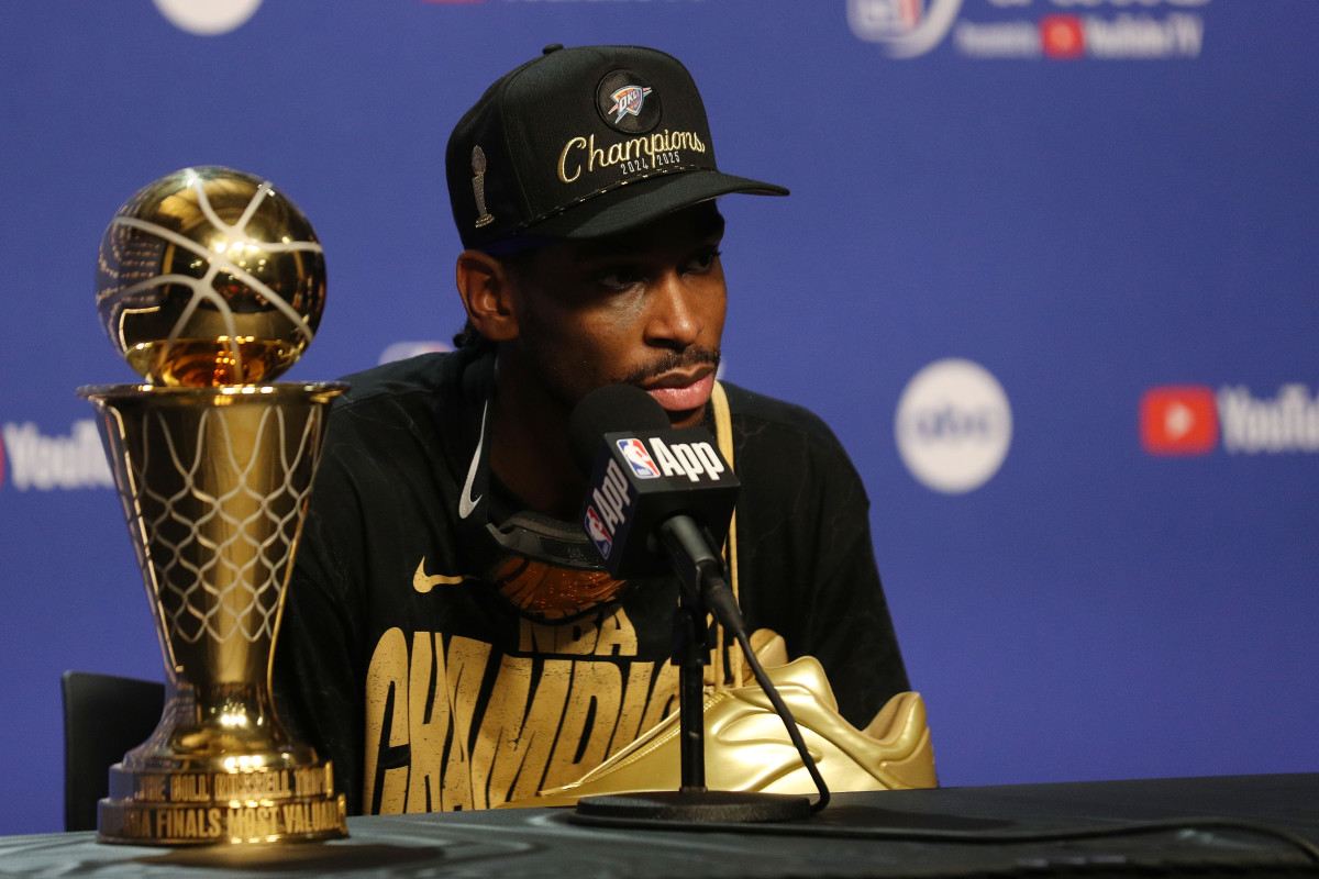 Shai Gilgeous-Alexander in a press conference with the NBA Finals MVP trophy