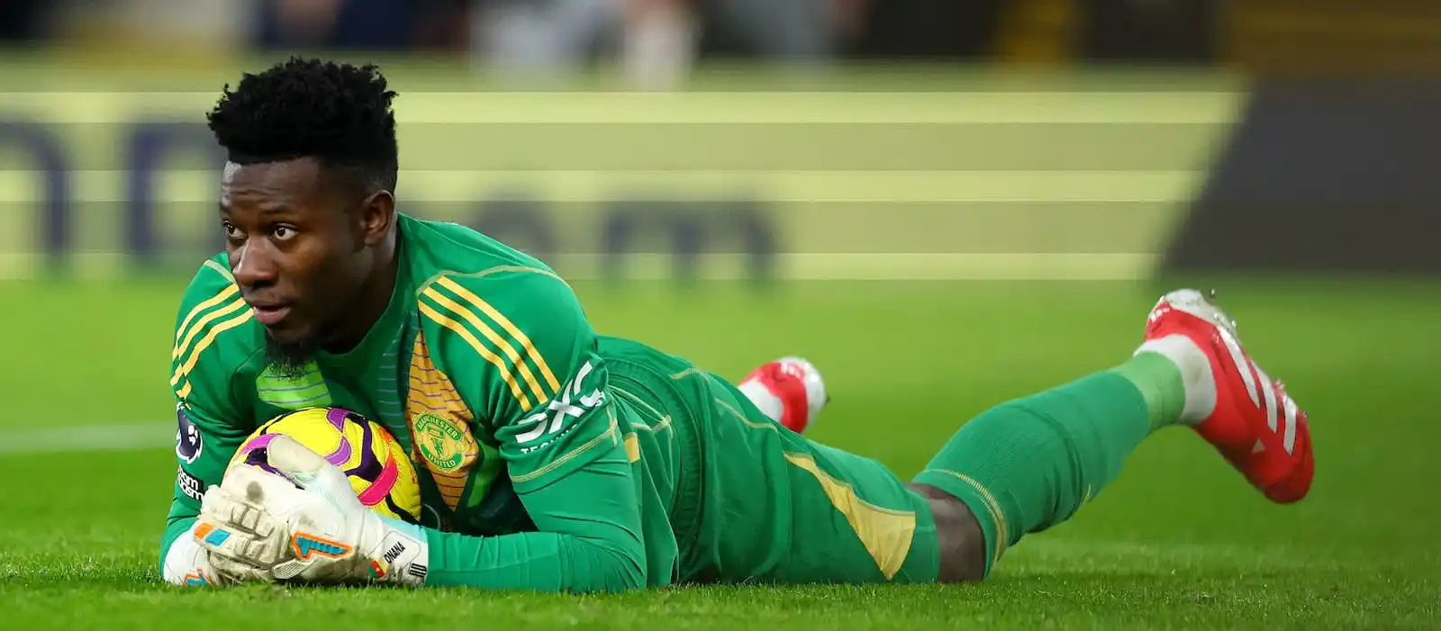 Andre Onana holding the ball on the ground