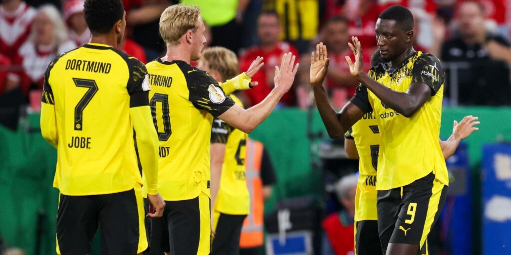 Borussia Dortmund players congratulate each other after scoring a goal