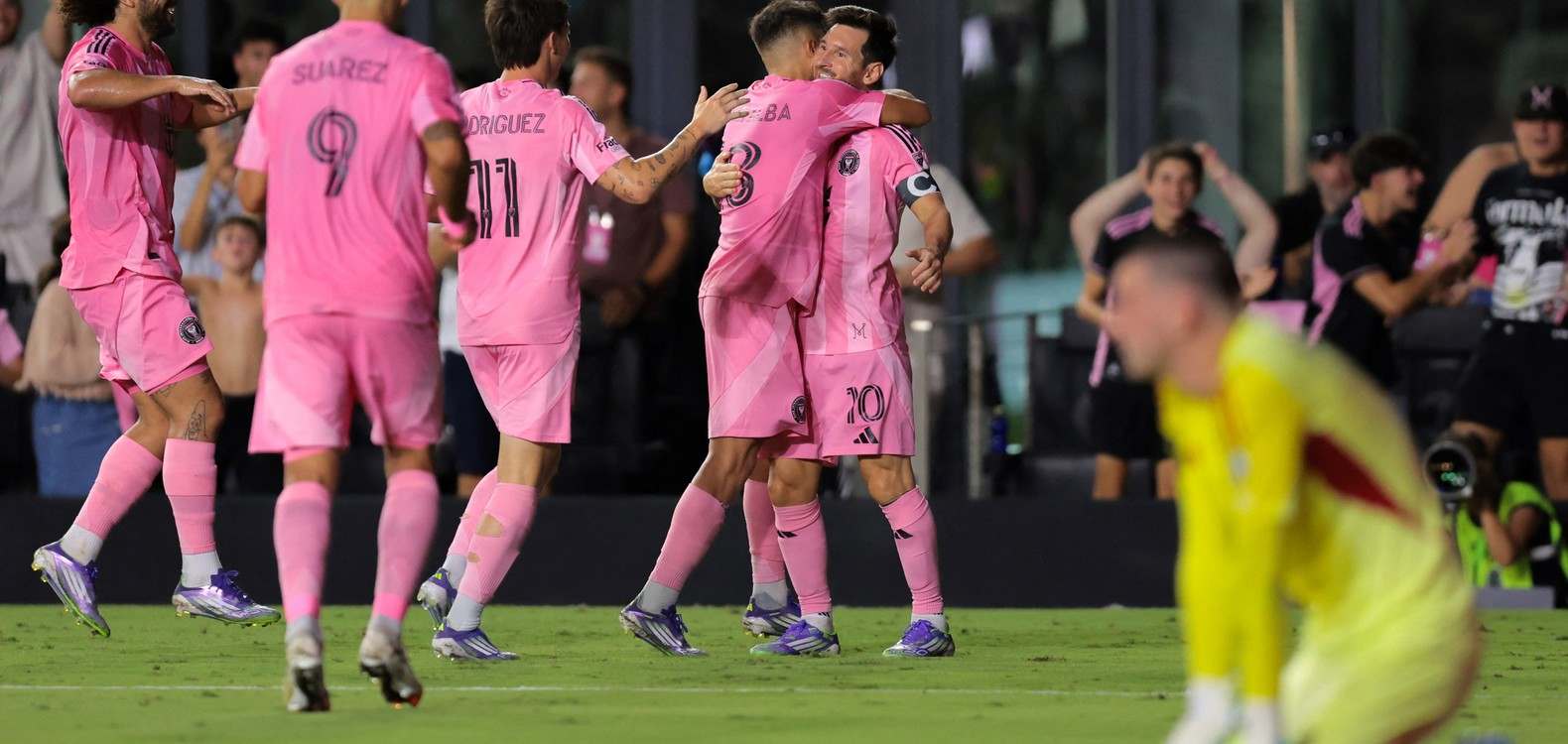 Inter Miami players rushing to hug Leo Messi after scoring against Orlando City