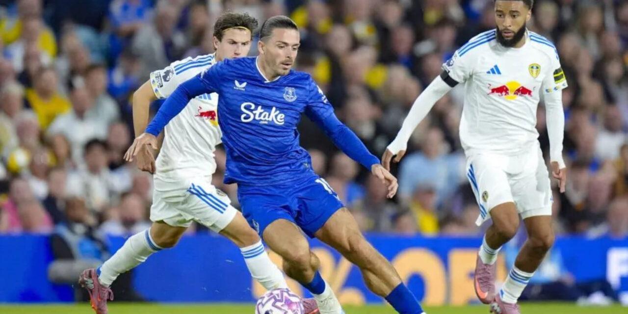 Jack Grealish protecting the ball from Leeds players in his debut for Everton