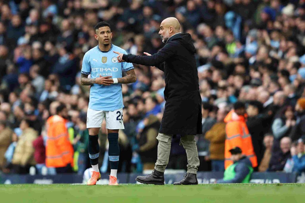 Savinho receiving instructions from Pep Guardiola