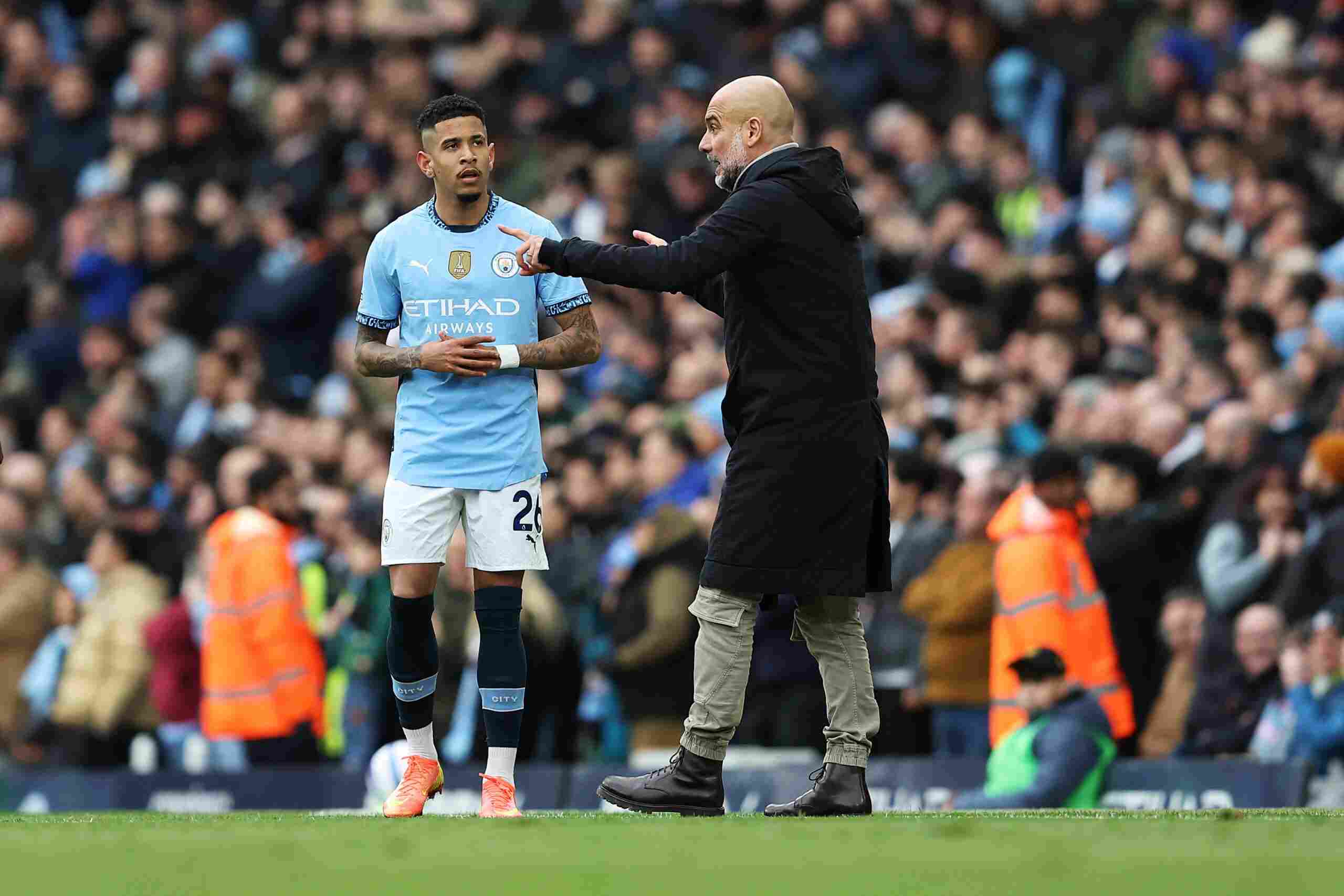 Savinho receiving instructions from Pep Guardiola