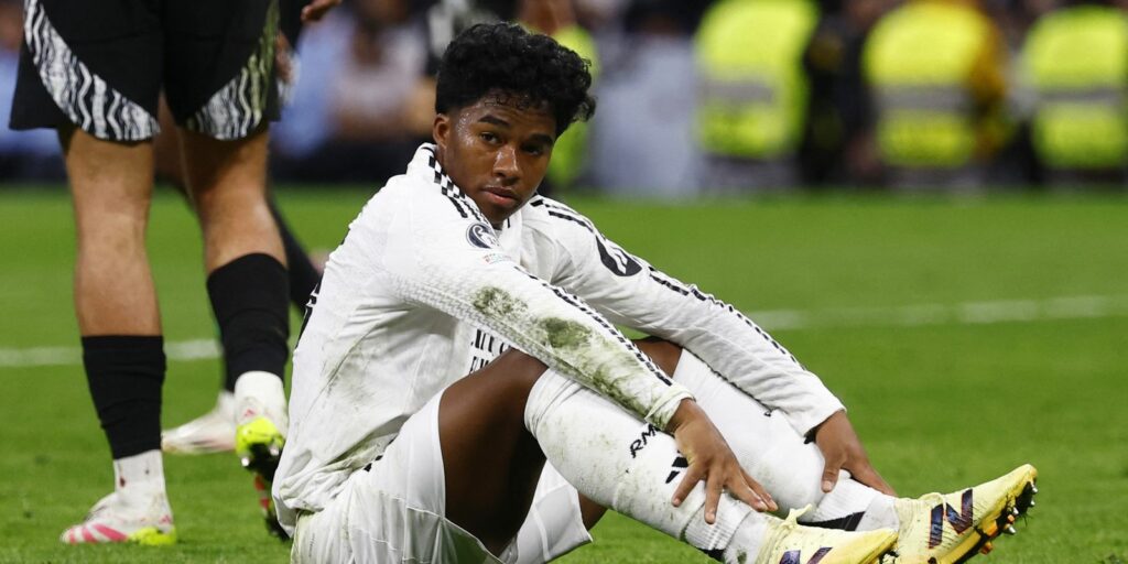 Real Madrid striker Endrick sitting on the pitch