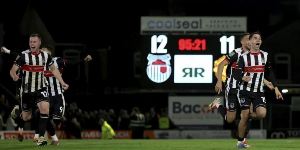 Grimsby Town players rush to celebrate after eliminating Manchester United from Carabao Cup