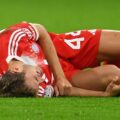 Bayern Munich defender Josip Stanisic laying injured on the field
